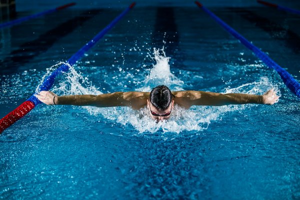 What are the essential nutrition tips for long-distance swimmers in training?